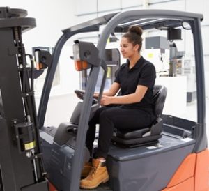 female driving forklift truck