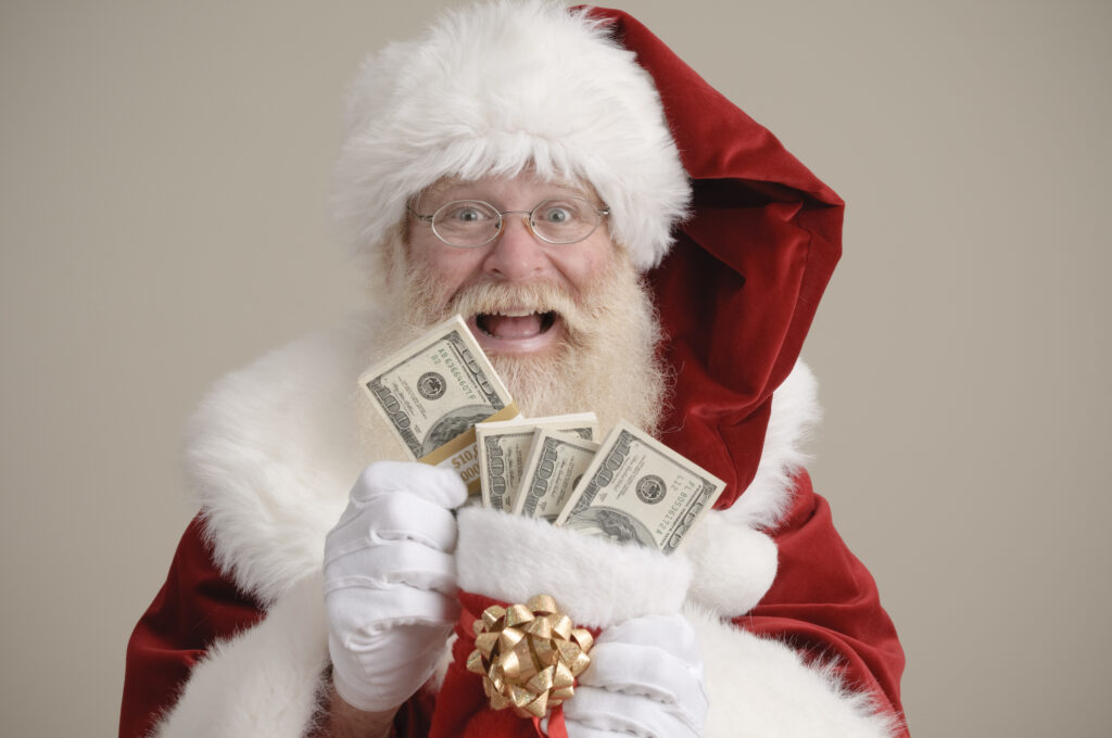 Happy Santa holding a stocking filled with money